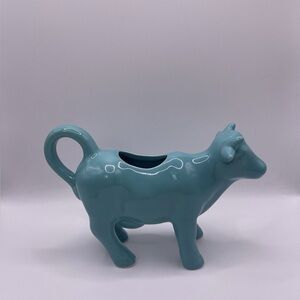 This is a Food Network ceramic cow creamer in a teal or turquoise blue color
